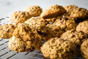 Baked gluten-free oatmeal cookies on wire rack.