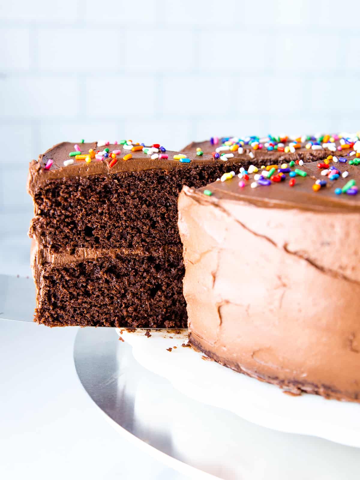 Slice being cut from an almond flour chocolate cake.