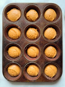 Gluten-free pumpkin muffin batter in a pan.
