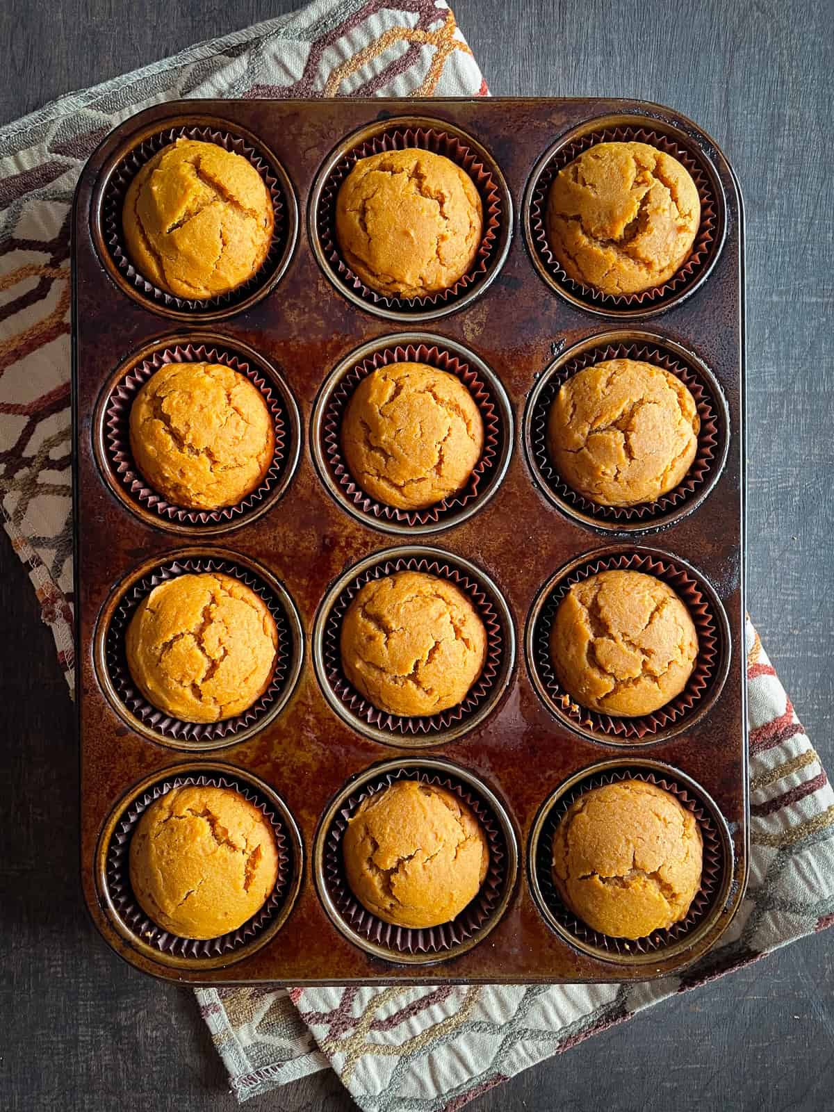 Gluten-free pumpkin muffins baked in a muffin pan.