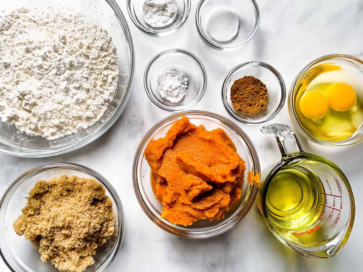 Ingredients for the gluten-free pumpkin muffin recipe measured and placed into bowls.