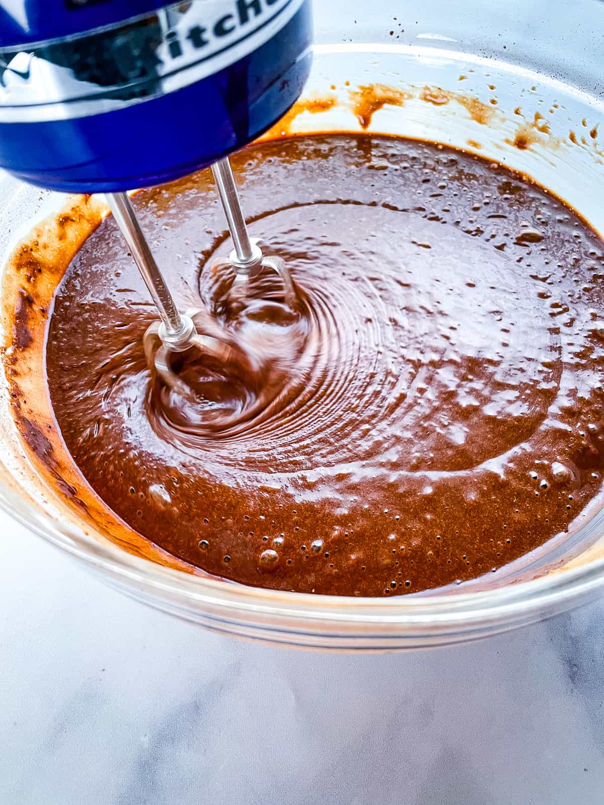 Gluten-free chocolate cake batter in a mixing bowl.