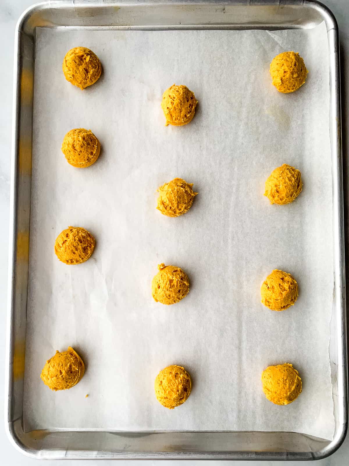Gluten-free pumpkin cookie dough on a baking sheet.