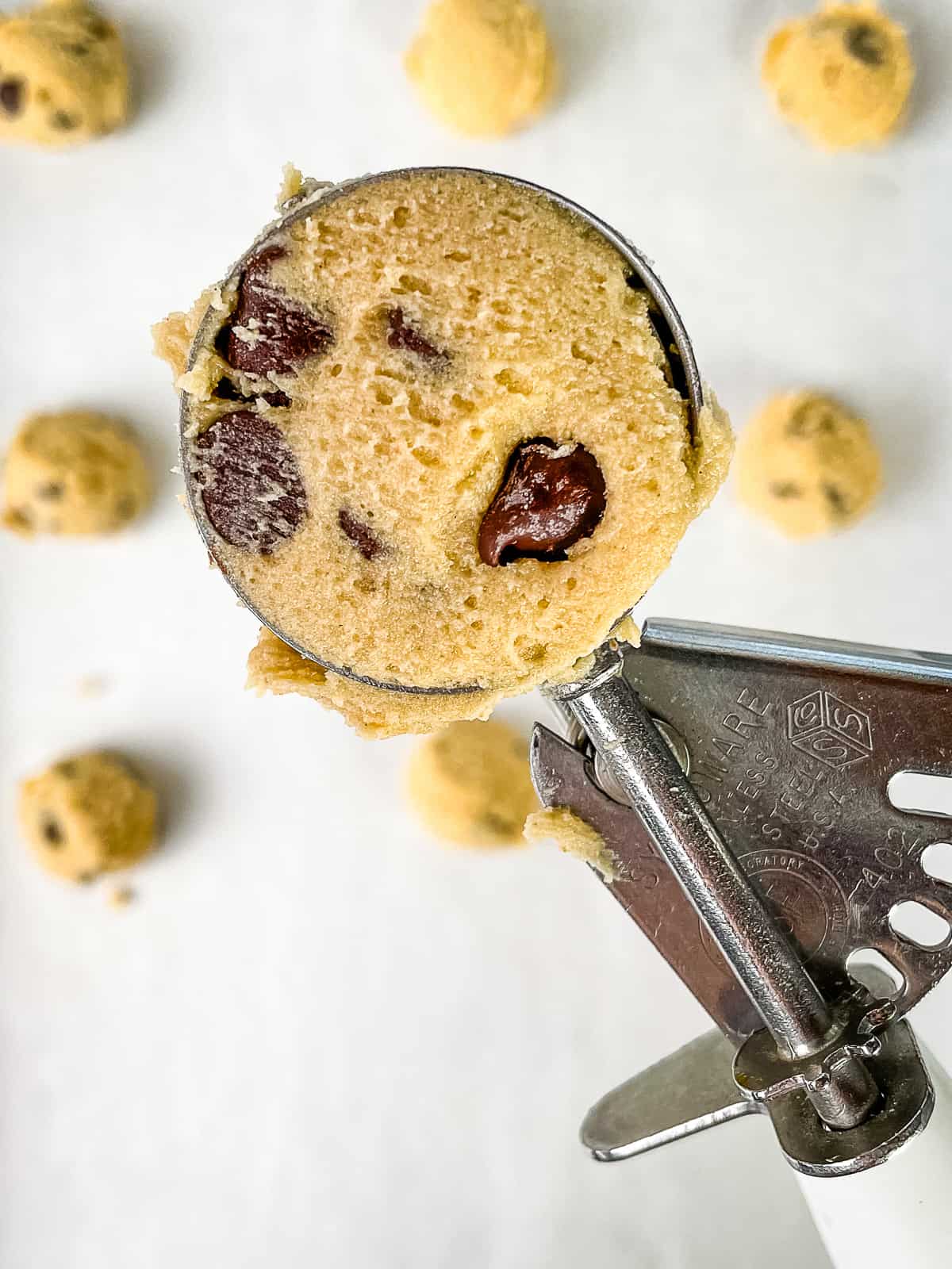 Cookie scoop filled with gluten-free chocolate chip cookie dough.