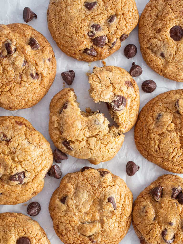 Gluten-free chocolate chip cookies on a piece of parchment paper.