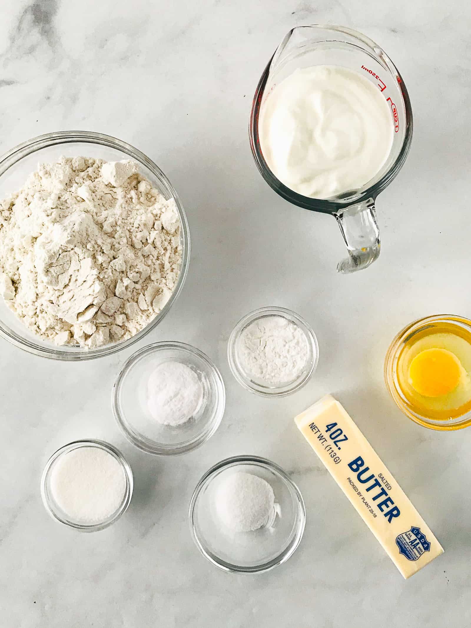 Ingredients for gluten-free biscuit recipe on a marble counter.