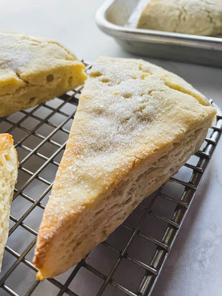 Gluten-free scone cooling on a wire rack.