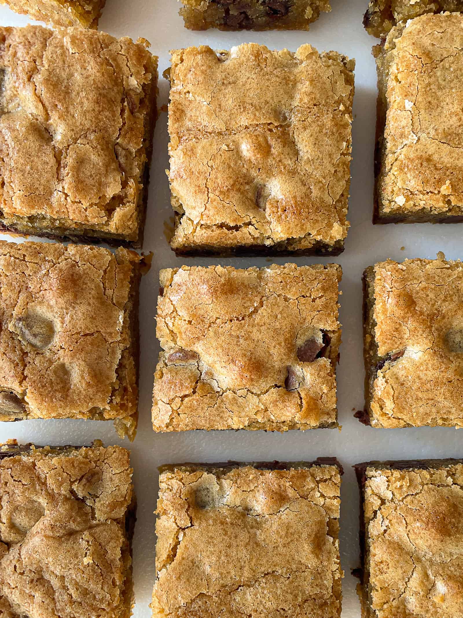 Gluten-free blondies cut into squares on a cutting board.