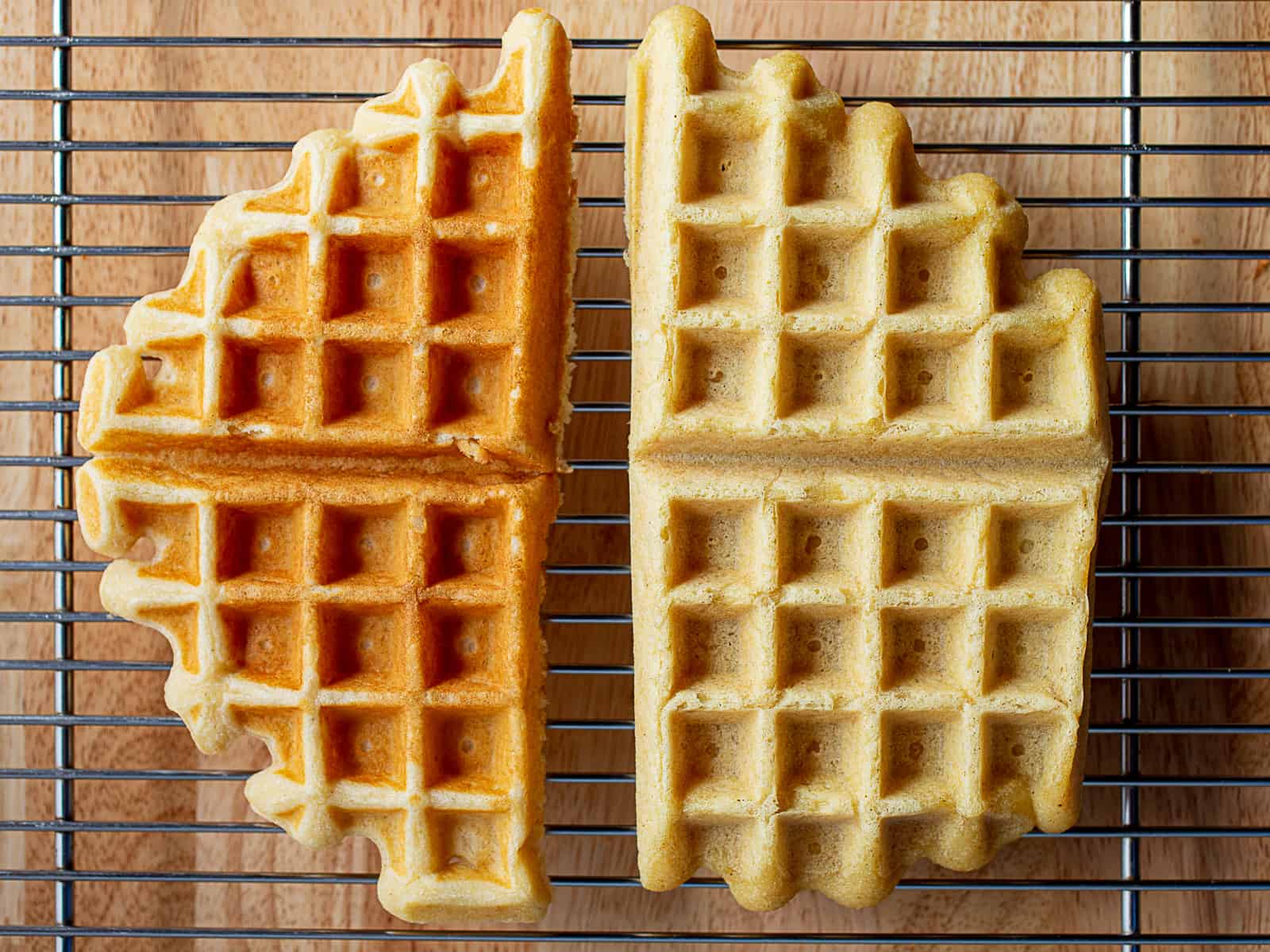 Gluten-free waffle on left. Gluten-free, egg-free, dairy-free waffle on right. The gluten-free, dairy-free, egg-free waffle is much lighter in color than the gluten-free waffle.