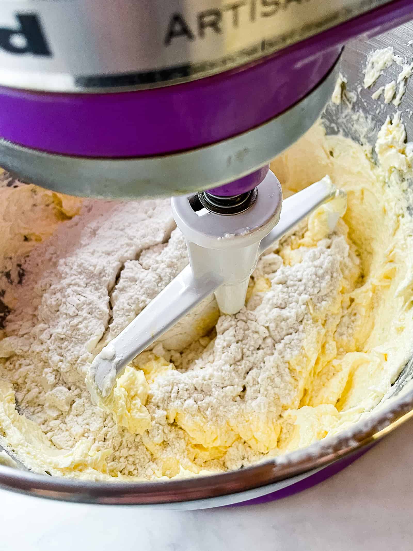 Adding flour to butter sugar mixture for gluten-free pound cake.