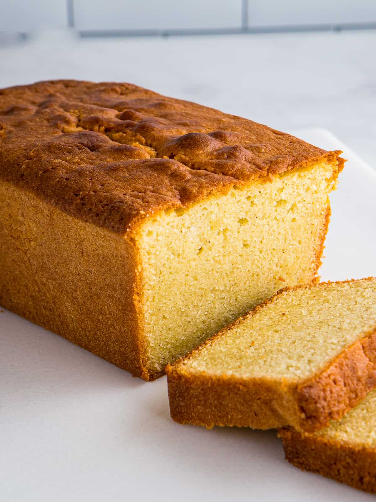 Baked gluten-free pound cake with two slices cut from it.
