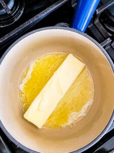 Melting butter in a pan for gluten-free brownies.