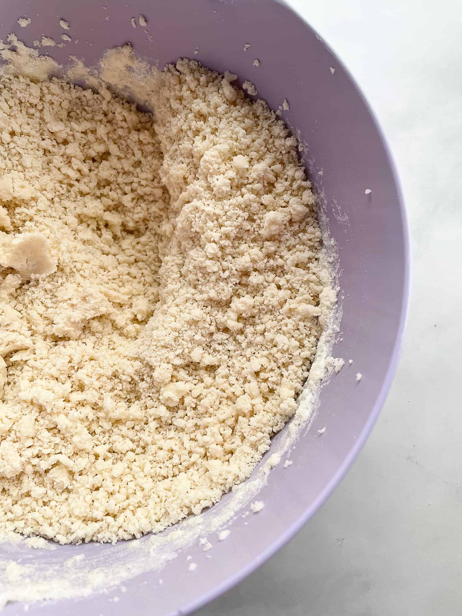 Crumbly gluten-free shortbread dough in a bowl.