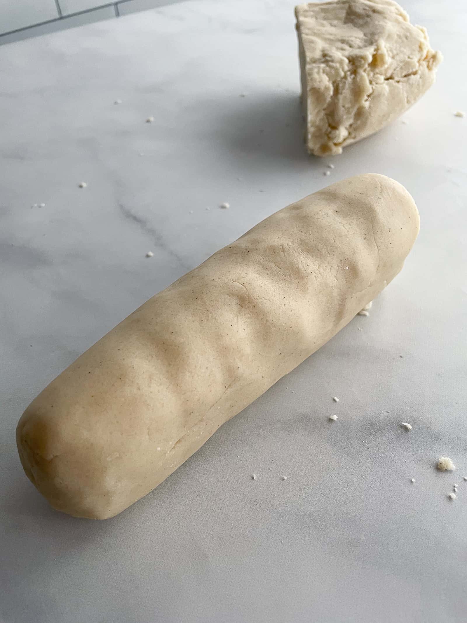 Gluten-free shortbread dough rolled into a log.
