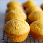 Gluten-free corn muffins cooling on a wire rack.