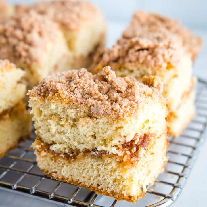 A slice of gluten-free coffee cake on a cooling rack.