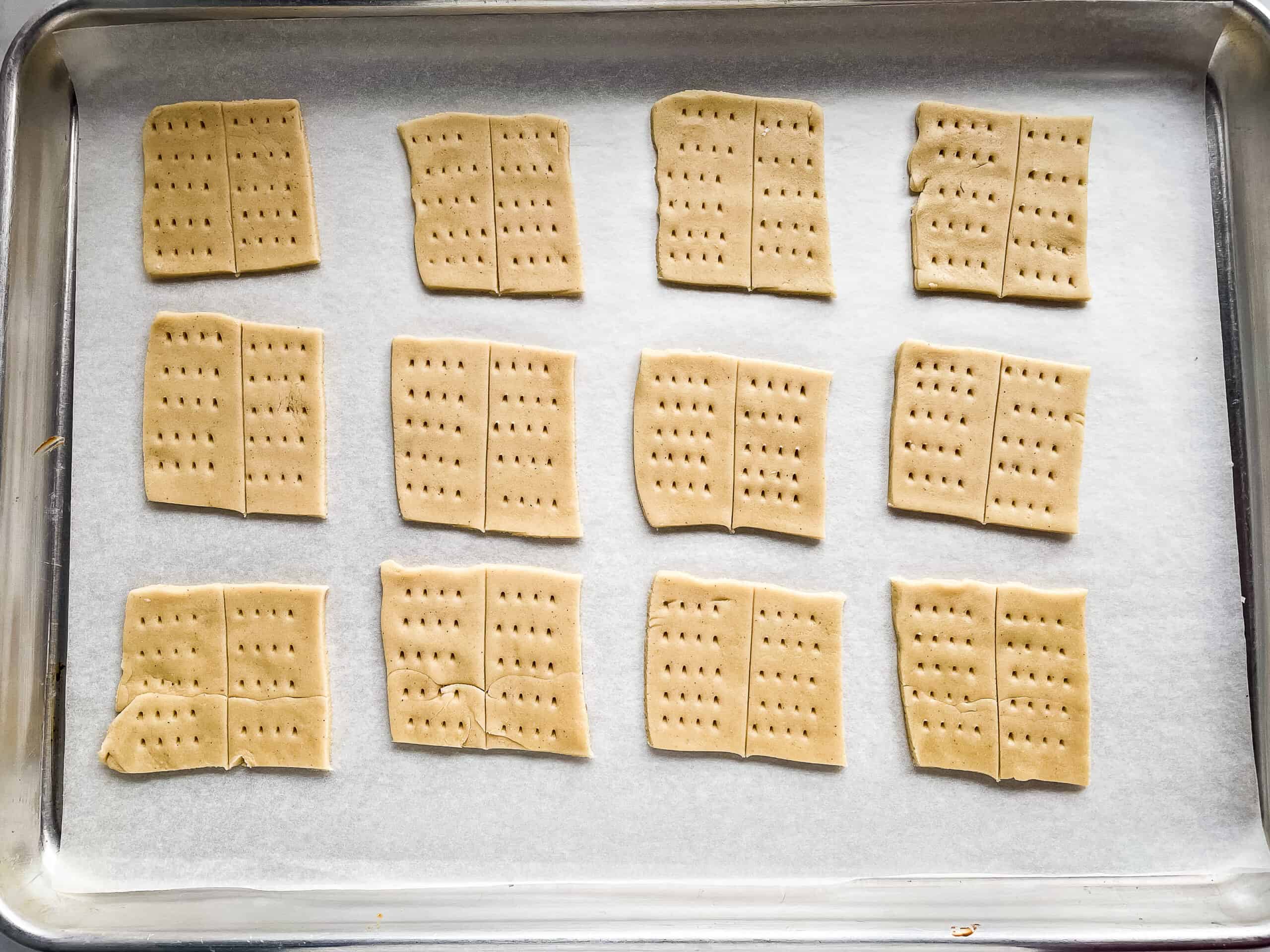 Gluten-free graham crackers cut into squares and dotted with holes.