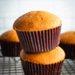 Two gluten-free pumpkin muffins stacked on each other.