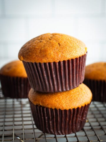 Two gluten-free pumpkin muffins stacked on each other.