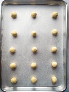 Gluten-free thumbprint cookie dough on a baking sheet.