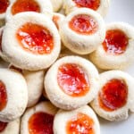 Gluten-free jam thumbprint cookies on a plate.