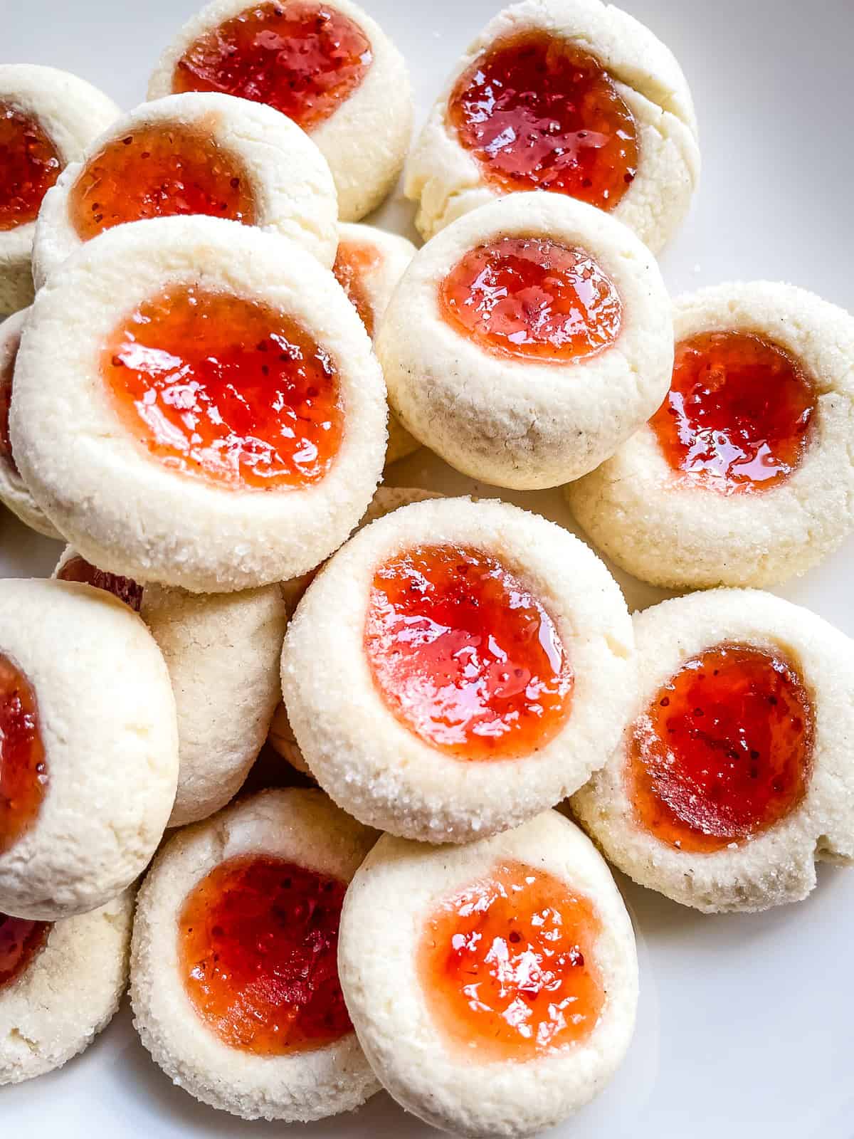 Gluten-free jam thumbprint cookies on a plate.