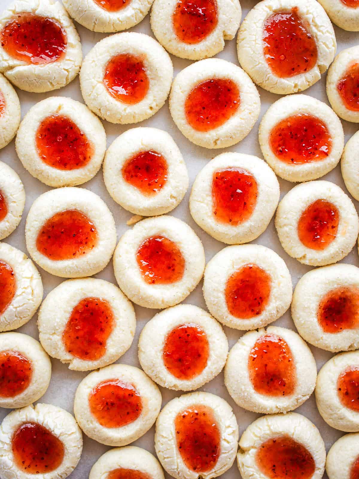 Gluten-free jam thumbprint cookies on a plate.