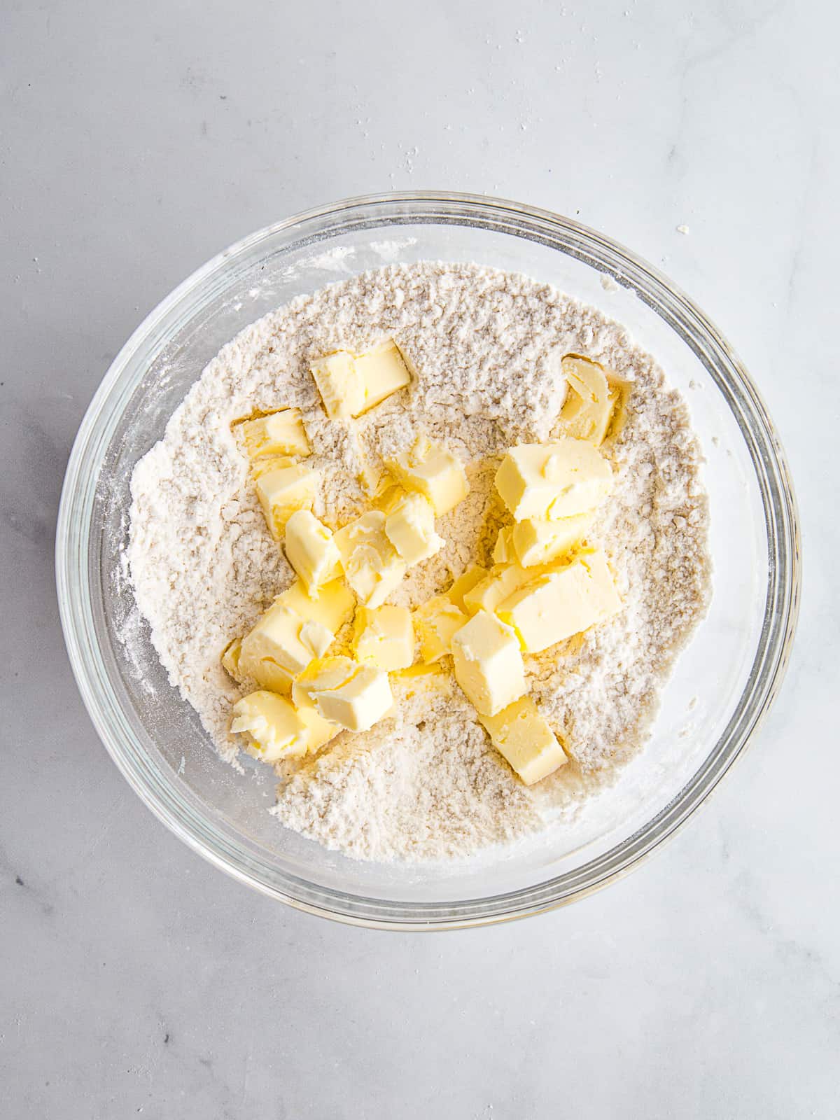 Butter cubes on gluten-free flour for a pie crust recipe