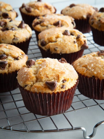 Gluten-free chocolate chip muffins cooling on a rack.