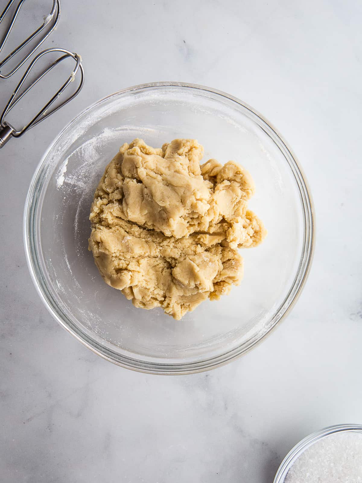 Gluten-free sugar cookie dough in a glass mixing bowl.