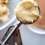 Gluten-free snickerdoodle dough on a cookie scoop.