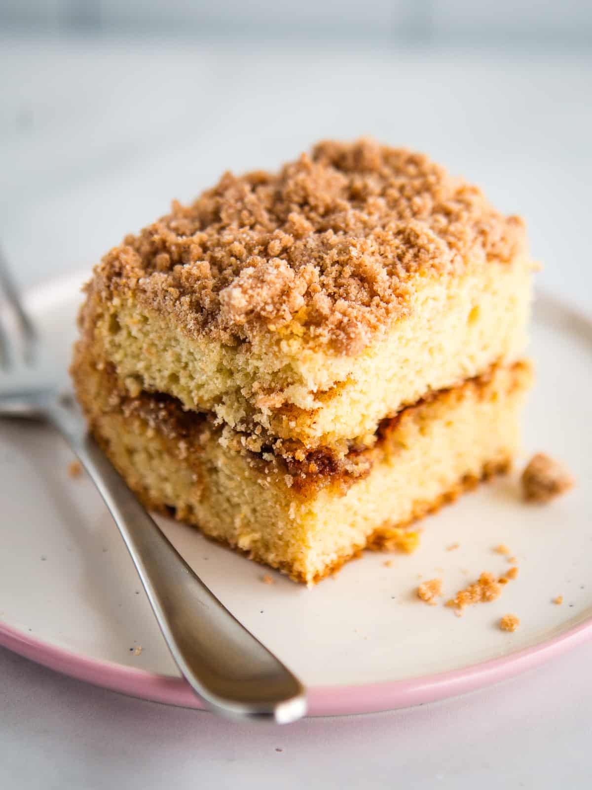 Gluten-free coffee cake slice on a plate with a fork.