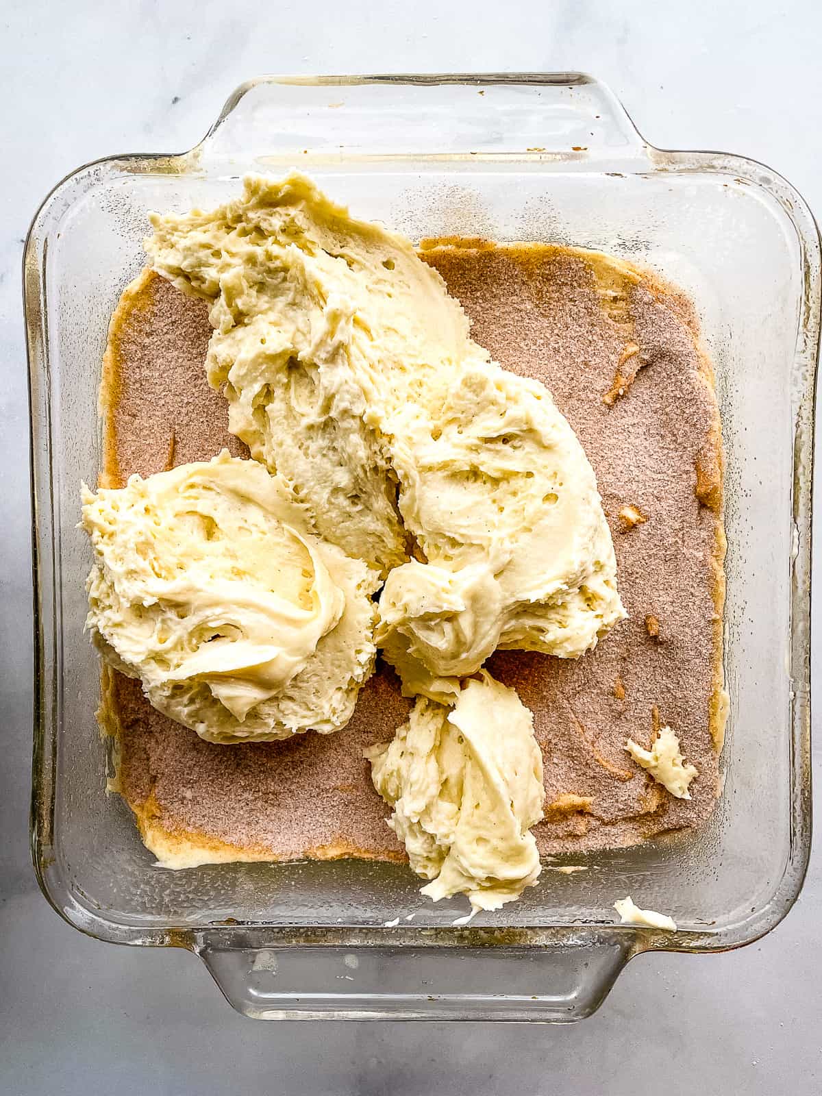 Gluten-free coffee cake batter and filling in a cake pan.