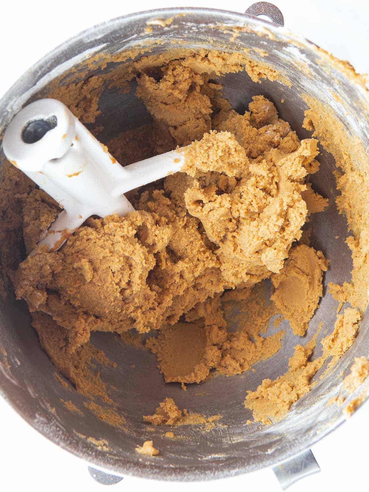 Gluten-free molasses cookie dough in a mixing bowl.