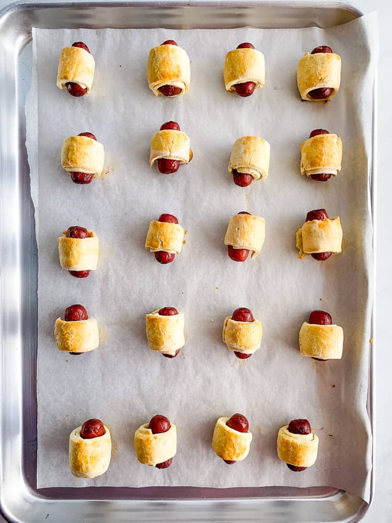 A tray of baked gluten-free pigs in a blanket.