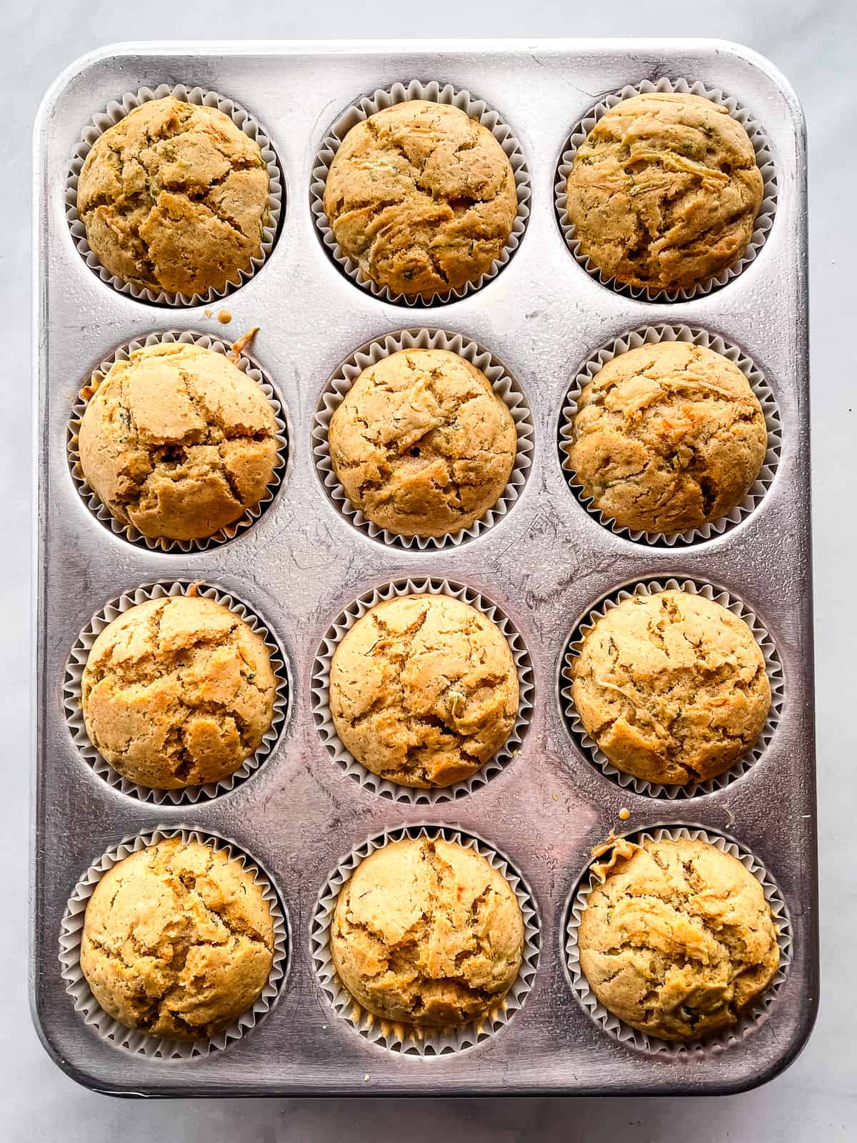 Baked zucchini muffins in pan.