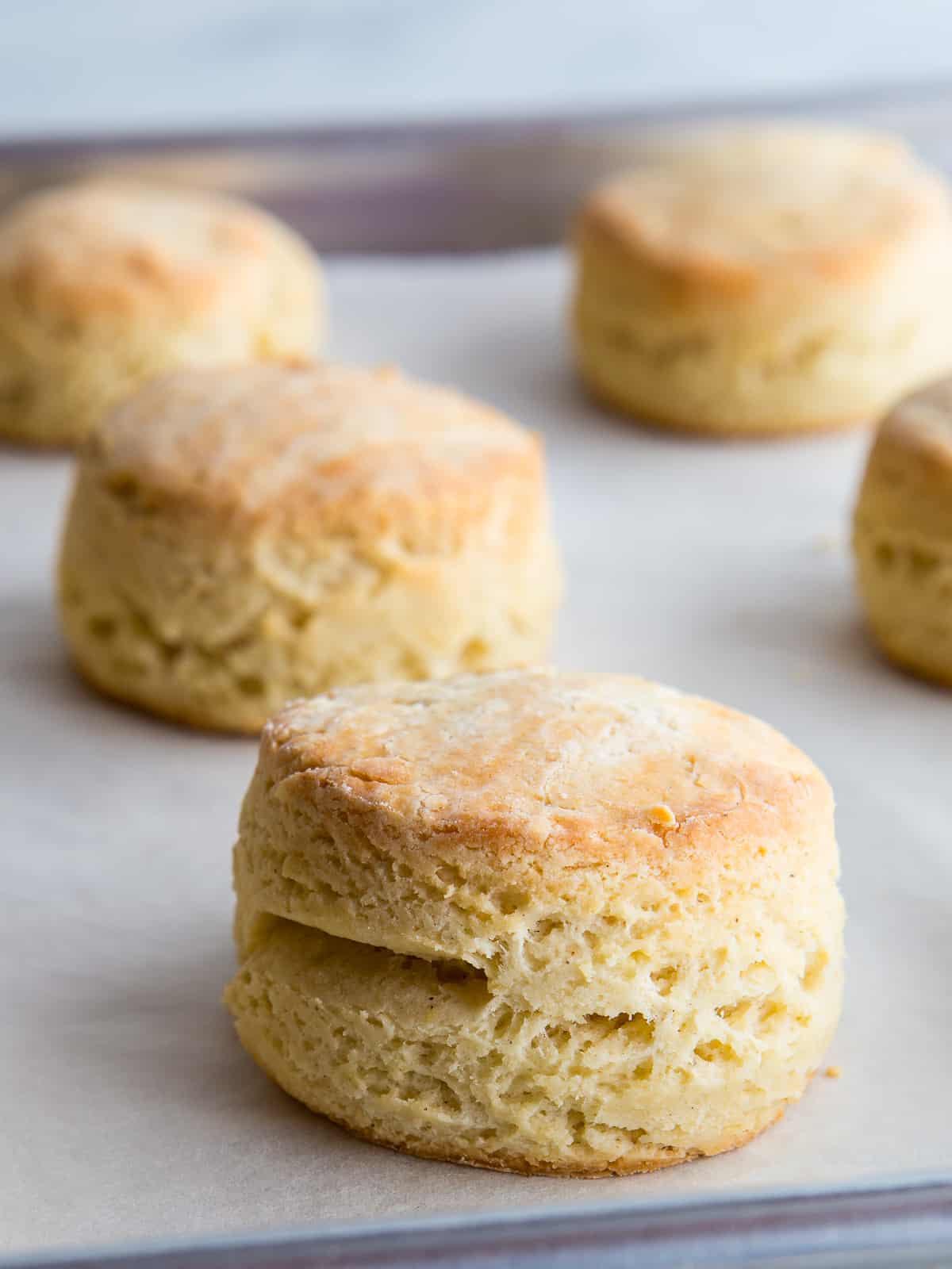 Baked gluten-free biscuits on a baking sheet.