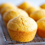 Gluten-free corn muffins cooling on a rack.