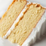 Gluten-free vanilla cake on a plate. The cake is frosted with vanilla buttercream.