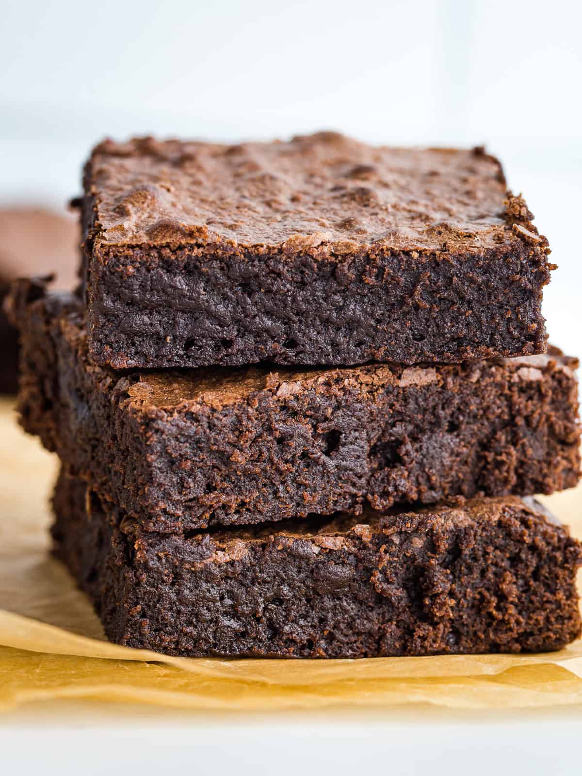 A stack of three gluten-free brownies.