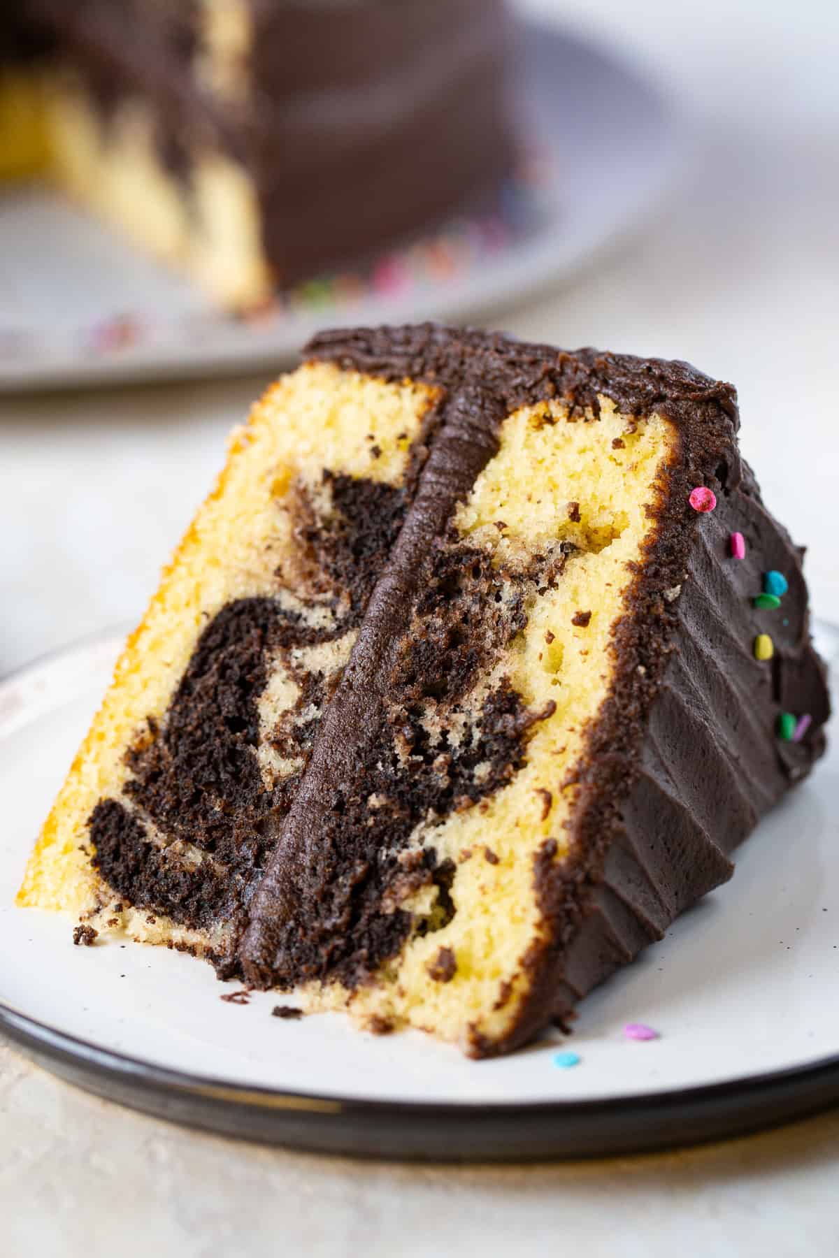 Slice of gluten-free marble cake on its side on a plate.