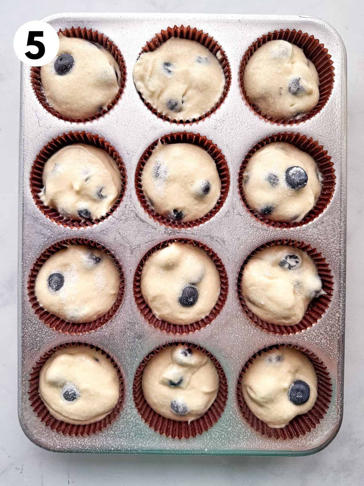 Gluten free blueberry muffin batter in a pan.