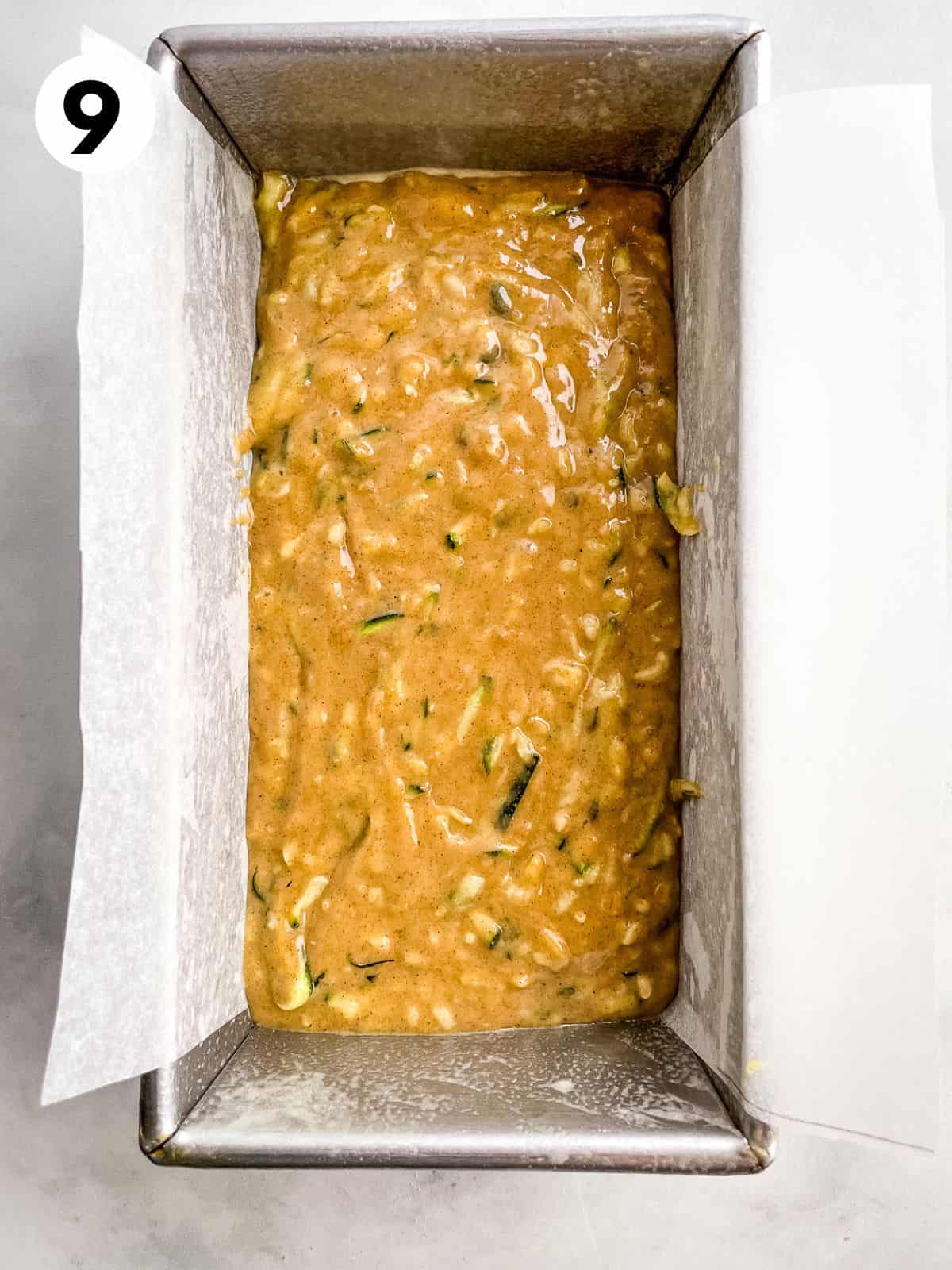 Gluten-free zucchini bread batter in a parchment-lined pan.