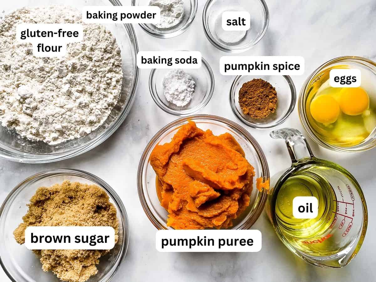 Ingredients for gluten-free pumpkin muffins in individual bowls on the counter.