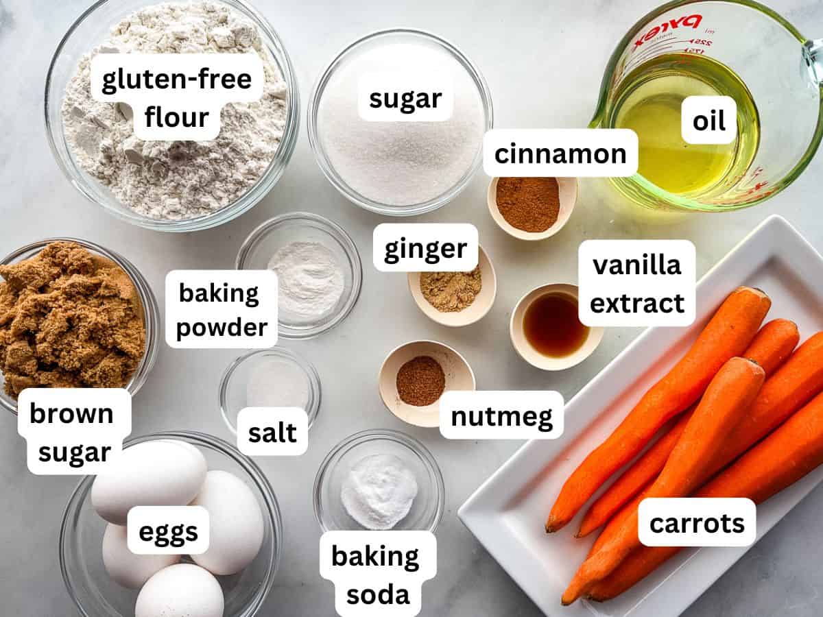 Ingredients for gluten-free carrot cake on the counter. The ingredients are measured into individual bowls.